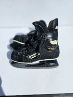 Full view of both Bauer Supreme 5000 skates showing overall design and condition