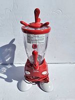 Full view of red Disney Mickey smoothie maker with jar, lid, stir stick and base