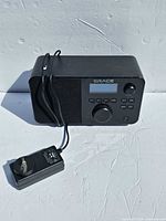 Front and side view of radio with power adapter