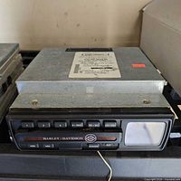 Front view of Harley-Davidson AM/FM CD radio showing faceplate, buttons and display