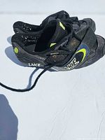 Side view of both shoes showing LAKE branding and Velcro strap