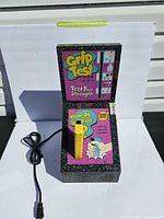 Full view of Grip Test machine showing cord, handle, graphics