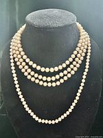 Front view showing both necklaces draped on bust