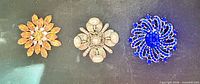 Group shot of all three brooches