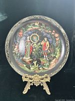Front view of plate on stand showing full artwork and border