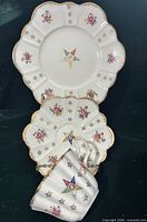 Front view of plate, saucer and teacup showing pattern
