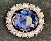 Front view showing blue center stone and rhinestone halo