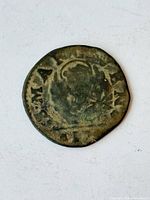 Obverse or reverse of the worn 17th-century Venetian coin