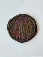 Reverse side with standing figure and legend