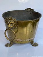 Full view of brass jardiniere showing handles and feet