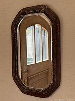 Full view of mirror hanging on wall