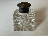 Front view of square crystal inkwell with sterling lid