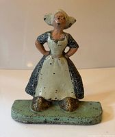 Full view of cast iron Dutch girl door stop on base