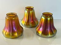 Three Steuben iridescent Aurene lamp shades front view