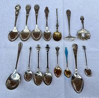 All fifteen spoons laid out to show variety and condition