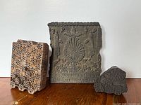 Group view of three carved wood printing blocks