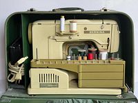 Bernina 730 sewing machine in green case, accessory base, foot controller, cords, spools