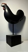 Full view of black wooden rooster on base