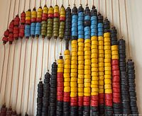 Close-up of beaded toucan showing colored wooden beads and string construction