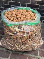 Full view of clear plastic bag filled with assorted wine and champagne corks