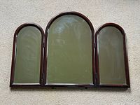 Front view of tri-fold mirror showing three panels and mahogany frame