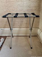 Front view of chrome folding luggage rack opened