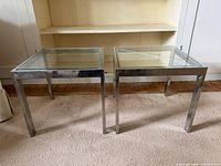 Both chrome and glass end tables side by side
