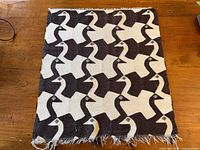 Full view of woven tapestry showing repeating geese pattern and overall condition