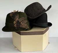 Front view of three hats stacked showing colours and styles