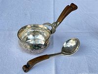 Brandy warmer and matching spoon showing hammered finish and wood handles