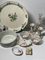 Group shot showing platter, bowl, decanter, candlesticks, baskets, small dishes, trinket box