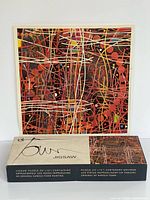 Puzzle box and reference image showing completed abstract painting
