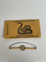Envelope front showing printed text and snake graphic