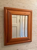 Front view of pine frame mirror on wall