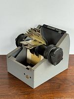 Angled view of grey Rolodex rotary card file showing knobs, card sleeves, and dividers