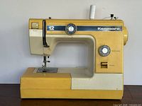 Front view of yellow Kenmore 12 sewing machine showing controls