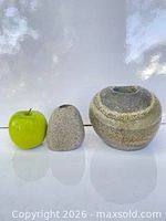 Apple beside both stone vases showing scale and shapes