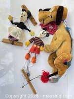 Group view of Minnie and Mickey marionette puppets and Pluto plush