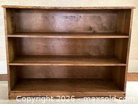 Front view of solid maple bookcase with three shelves
