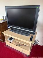 Front view of Sylvania TV on blonde stand