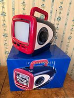 Claybrooke mini TV on top of its box showing screen, handle and side dial