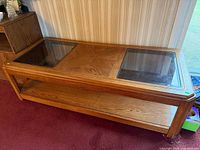 Full view of rectangular oak coffee table with two glass inserts and lower shelf
