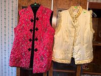 Front view of both vests hanging side by side