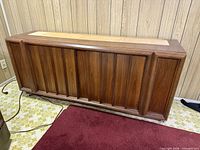 Front view of wood buffet showing paneled doors and overall design