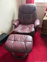 Front view of purple leather swivel chair and ottoman