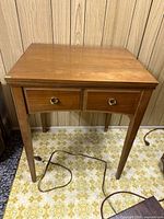 Sewing table front view closed showing two faux drawers and legs