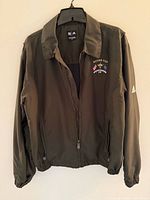 Front view of Adidas Ryder Cup Oakland Hills jacket hanging