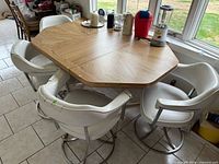 Dining set full view showing table top, four chairs, materials, wear