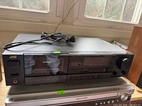 Front view of JVC TD-X331 cassette deck atop another component