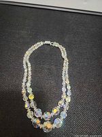 Entire necklace arranged to show two strands and beads